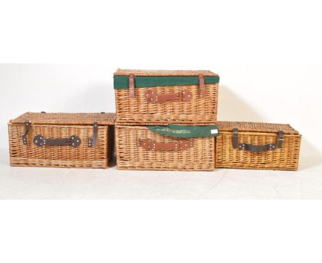 A collection of 20th century hamper / wicker baskets, each of rectangular form with leather strapping and hinges tops. One wi