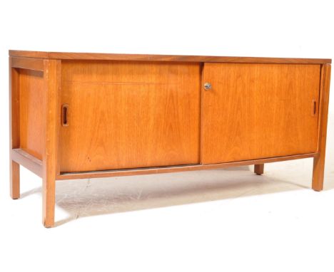A retro vintage mid 20th century circa 1960s sideboard credenza having two sliding doors opening to reveal a shelved interior