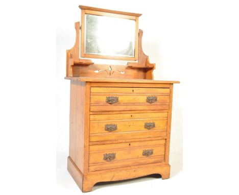 An early 20th Century Edwardian ash wood dressing table - chest of drawers having a central swing mirror having a configurati