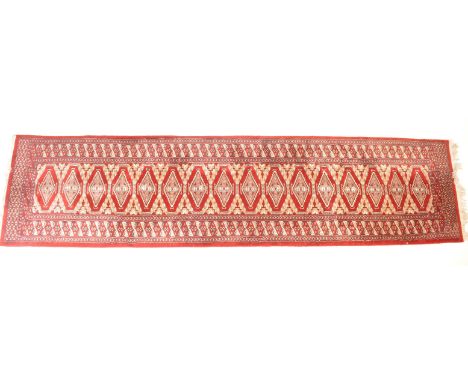 A vintage 20th century floor runner rug having&nbsp; red background with black geometric patterns. Measures&nbsp;315cm x 77cm
