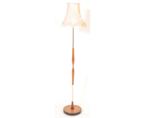 A retro vintage circa 1970s mid 20th century teak and metal floor standing / standard lamp having wooden embellishments to th