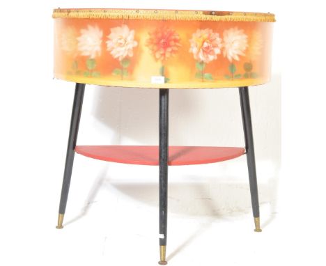 A retro vintage mid 20th century circa 1950s Loughton half moon hall table having flowers inset to the frieze raised on tripo