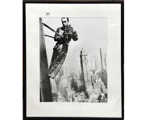 A large framed photographic print of a photographer on a New York skyscraper, frame size 74 x 84cm.