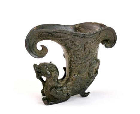 A Chinese archaic form bronze libation cup decorated with a dragon, H. 9.5cm.