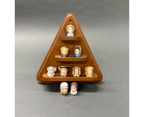 A set of hand painted thimbles by Keith Harrison of Royal Doulton, including Henry VII and his six wives, Lord Nelson and Lad