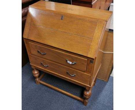 A three drawer light oak drop down bureau, 100 x 74 x 38cm.