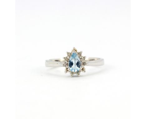 An 18ct white gold ring set with a pear cut aquamarine surrounded by brilliant cut diamonds, (M).