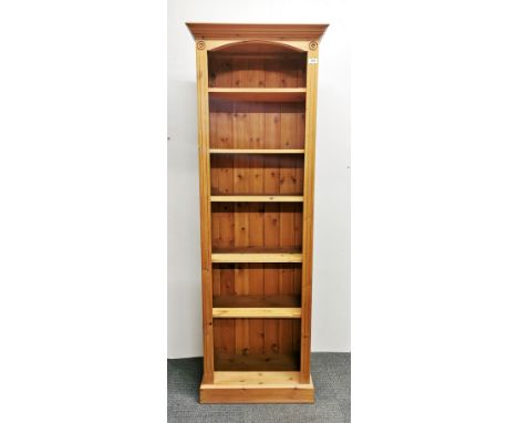 A slim six shelf pine bookcase, 187 x 63 x 32cm.