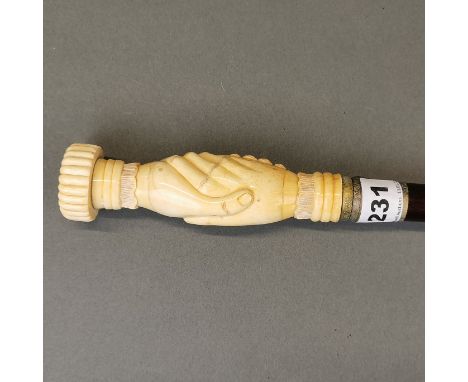An impressive carved bone handled walking stick, with inset tortoise shell top, L. 94cm.