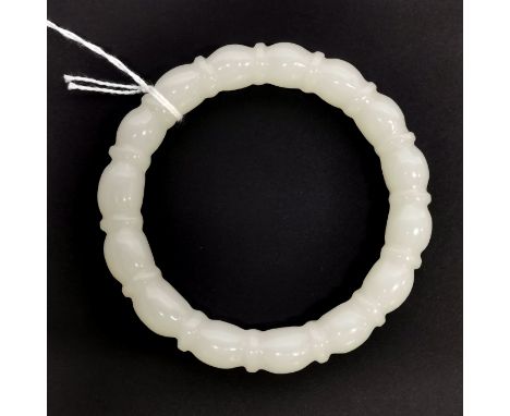 A Chinese carved mutton fat jade bamboo design bangle, external Dia. 8cm, internal Dia. 6cm, W. 1cm.