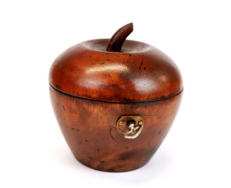 A carved wooden apple shaped tea caddy.