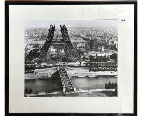 A large framed photographic print of the construction of the Eifel Tower, frame size 74 x 84cm. Some damage to frame.