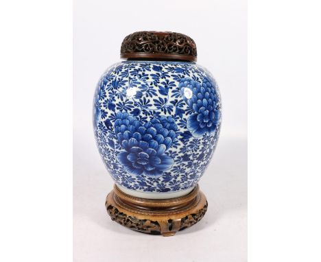 Early 19th century Chinese blue and white ginger jar with floral design, with pierced hardwood cover and stand, 30cm tall ove