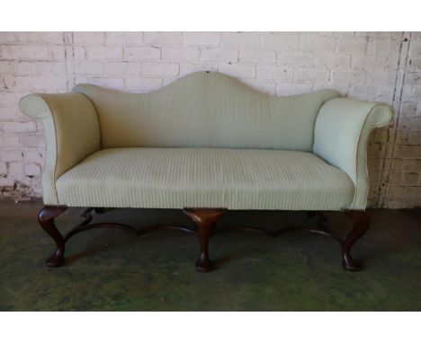 Antique mahogany framed two-seater sofa, having recurved serpentine top rail, out swept scroll arms, upholstered in green str