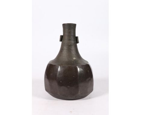 Janet Leach (1918-1997) for St Ives Pottery, a studio pottery cut sided bottle vase, 23cm tall.  Pitting to the glaze part, n