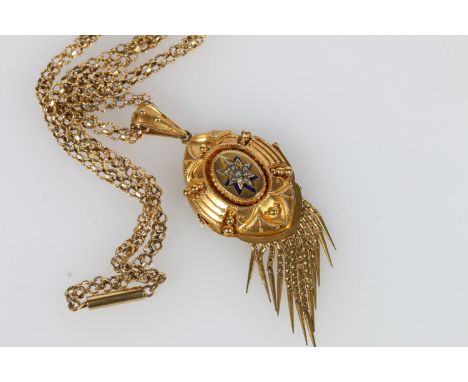 Victorian yellow metal mourning pendant set with seed pearls against a black enamel eight-point star and graduated tassel dro