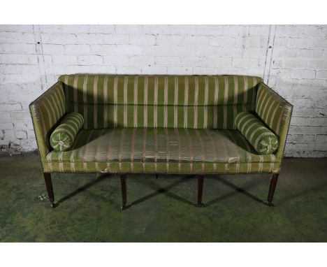Georgian period mahogany framed three seater sofa upholstered in green silk fabric, raised on reeded square tapering supports