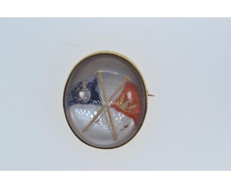 Reverse intaglio rock crystal brooch backed in yellow metal, tests positive for 14ct gold, with crossed flags design, 32 x 28