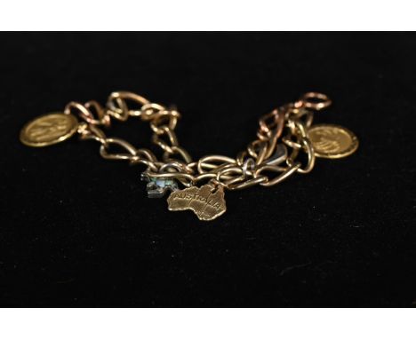 Yellow metal charm bracelet with three 9ct gold charms and two silver opal set charms, yellow metal bracelet tests positive f