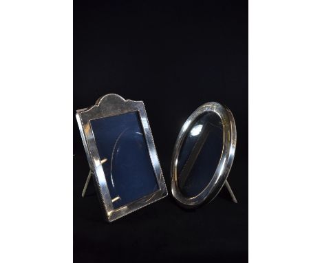 Two silver photo frames, including: a rectangular frame by Carr's of Sheffield Ltd, Sheffield 1990, 24 x 16.5cm; and an oval 