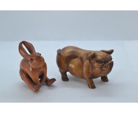 Oriental carved boxwood pig, 7cm long. Together with a carved and signed hare netsuke, 5cm high. 