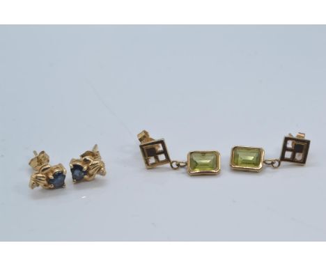 Two pairs of yellow metal gold earrings, test positive for 9ct gold, set with sapphire and peridot respectively, gross weight