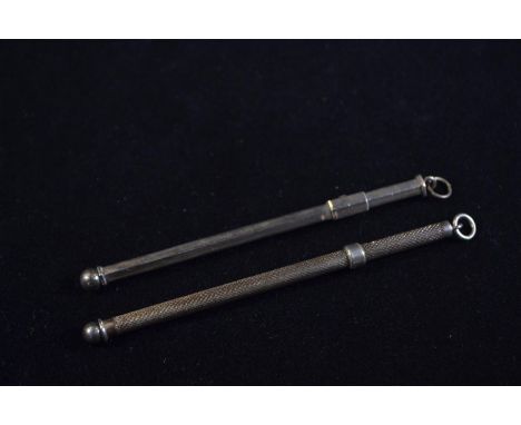 Two silver swizzle sticks, including one with engine turned decoration marked 'Sterling Silver' and the other plain marked 'S