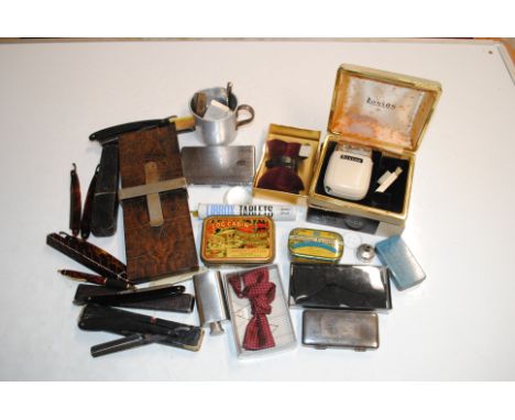 A box containing cigarette lighters, cigarette case, various Rolls razors, bow ties etc.