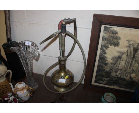 A brass hookah pipe with coloured stone decoration