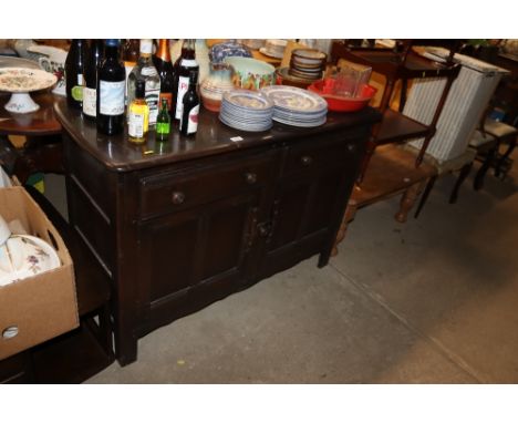 An Ercol style sideboard fitted two drawers, raised on cupboard base 