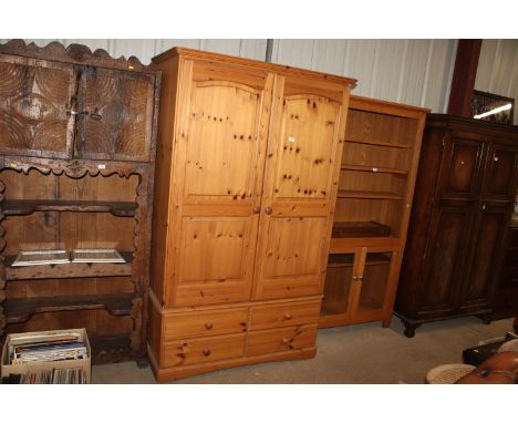 A modern pine wardrobe fitted four drawers below 