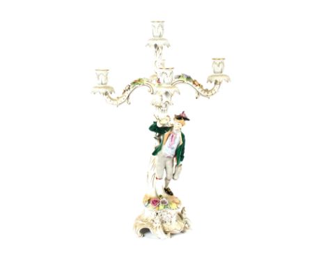 A pair of Dresden five light candelabra with floral encrusted decoration, the columns with street vendors, approx. 58cm high