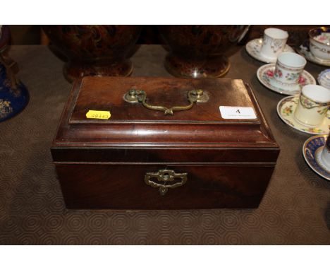 A 19th Century mahogany twin compartment tea caddy of sarcophagus shape 