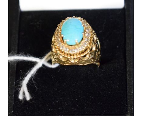 An Iranian yellow metal ring, diamond and turquoise set cluster ring, central oval turquoise cabochon, surrounded by a band o