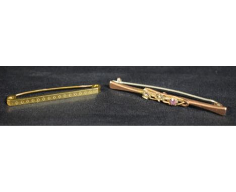 Brooches - an Edwardian seed pearl and pale pink tourmaline floral  bar brooch, stamped 9ct, 49mm long;  another smaller engi