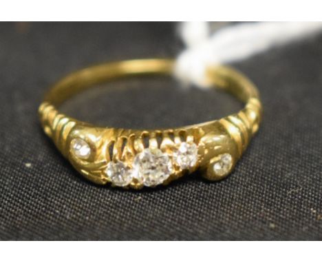 A five stone diamond line ring. S shaped crest inset with a central row of three graduated diamonds, flanked either side by a