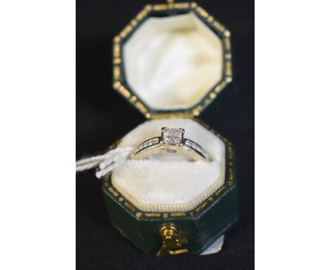 A chequer board diamond cluster ring, central cluster of four square cut diamonds, above graduating five stone diamond channe