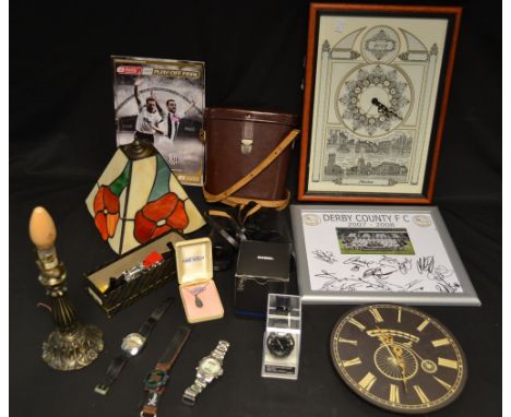 A pair of binoculars, cased; Ilkeston 2002 commemorative wall clock; wristwatches; Derby County ephemera; Tiffany-type lamp; 