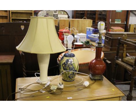 A Chinese style red glazed table lamp; together with two other table lamps