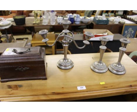 A George III mahogany adapted tea caddy; together with a silver plated three branch candelabra and matching candle sticks