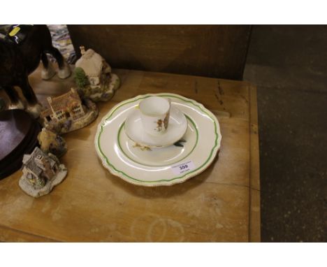 A Tuscan china cup and saucer depicting a teddy bear playing cricket and a Royal Winton plate depicting a bear flying an aero