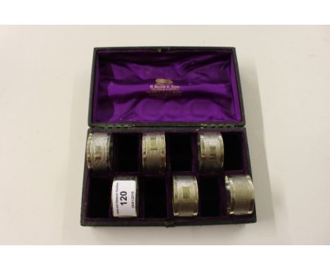 A cased set of six silver plated napkin rings with engine turned decoration