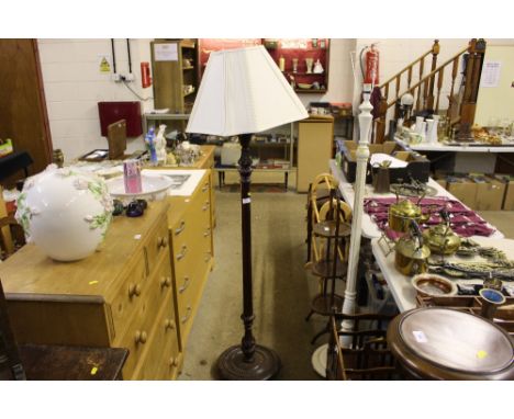A mahogany standard lamp and shade