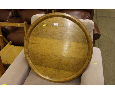 A light oak circular tray