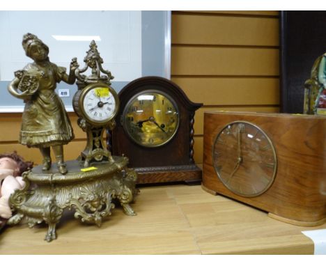 A polished barley-twist clock, a mid century veneered table clock & a gilt spelter figural clock
