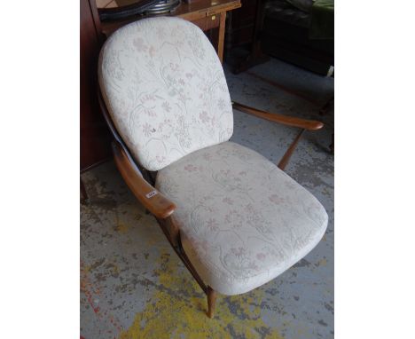 An Ercol fleur-de-lys & spindle back cushion seated armchair