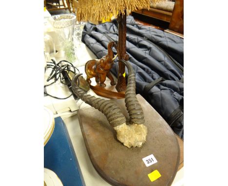 A pair of mounted antelope horns, a carved elephant table lamp etc