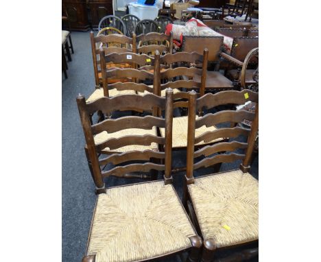 A set of six rush seated ladder back chairs, three Ercol arched back Prince of Wales feather chairs & four wheel back chairs