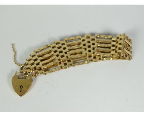 A 9ct yellow gold gate bracelet with heart shaped padlock, 18.9grms