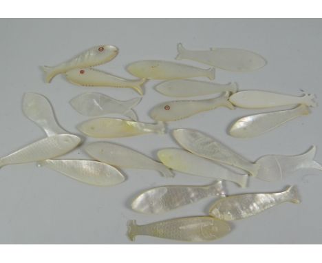 A collection of approximately twenty mother of pearl novelty gaming counters in the form of fish with incised scale decoratio